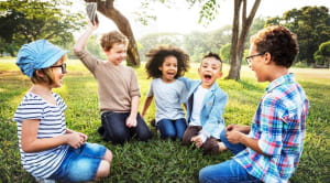 Children sat on lawn playing